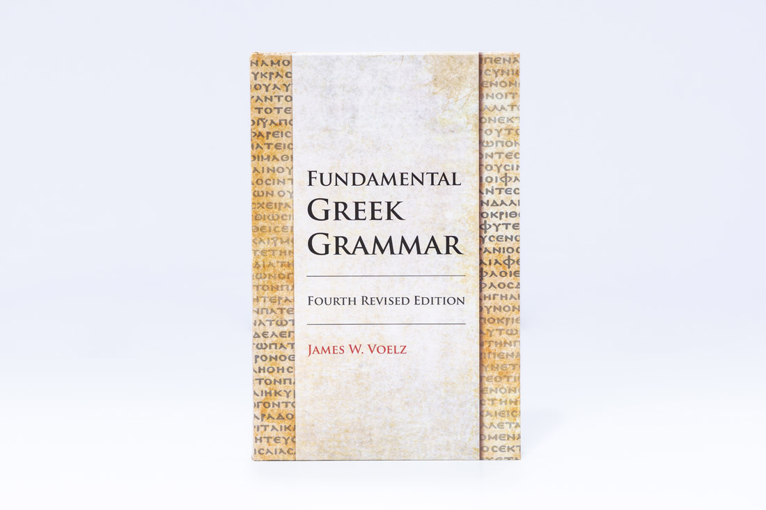 Fundamental Greek Grammar Fourth Revised Edition textbook by James W. Voelz with white cover featuring vertical columns of ancient Greek text on gold parchment background.